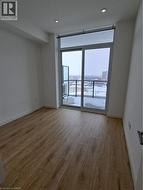 Unfurnished room with recessed lighting, baseboards, and wood finished floors -