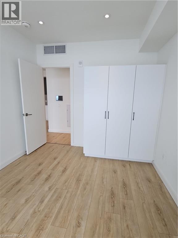 Unfurnished bedroom featuring baseboards, recessed lighting, visible vents, and light wood-style floors - 741 King Street W Unit# 1207, Kitchener, ON - Indoor Photo Showing Other Room