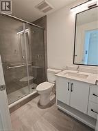 Bathroom featuring toilet, a stall shower, visible vents, and vanity -