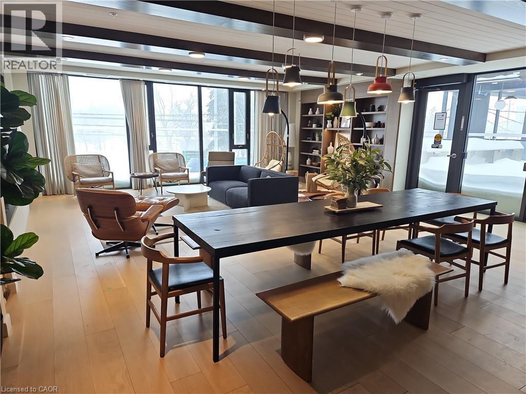 Dining space with beam ceiling, light hardwood / wood-style flooring, and plenty of natural light - 741 King Street W Unit# 1207, Kitchener, ON - Indoor