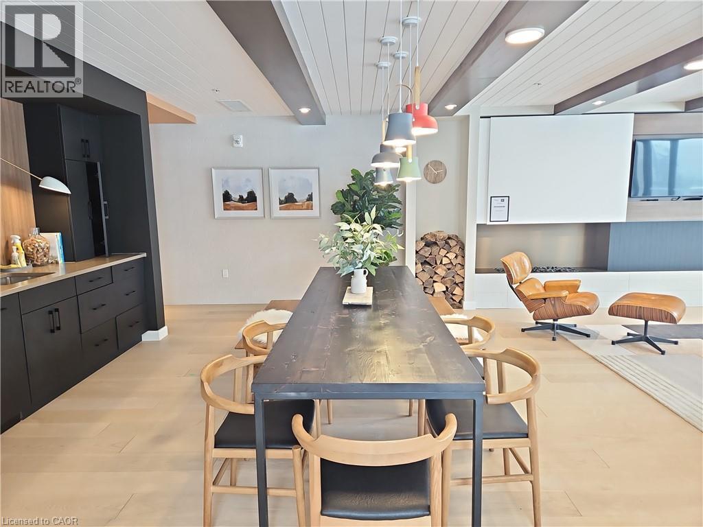 Dining space featuring sink, beam ceiling, wood ceiling, and light hardwood / wood-style flooring - 741 King Street W Unit# 1207, Kitchener, ON - Indoor Photo Showing Dining Room