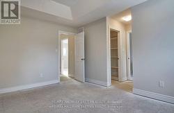 Primary Bedroom walk-in closet w/built-in shelving -