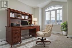 Second bedroom over garage staged as office -