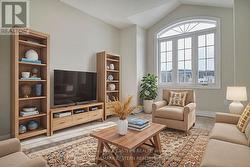 Second bedroom over garage staged as sitting room -