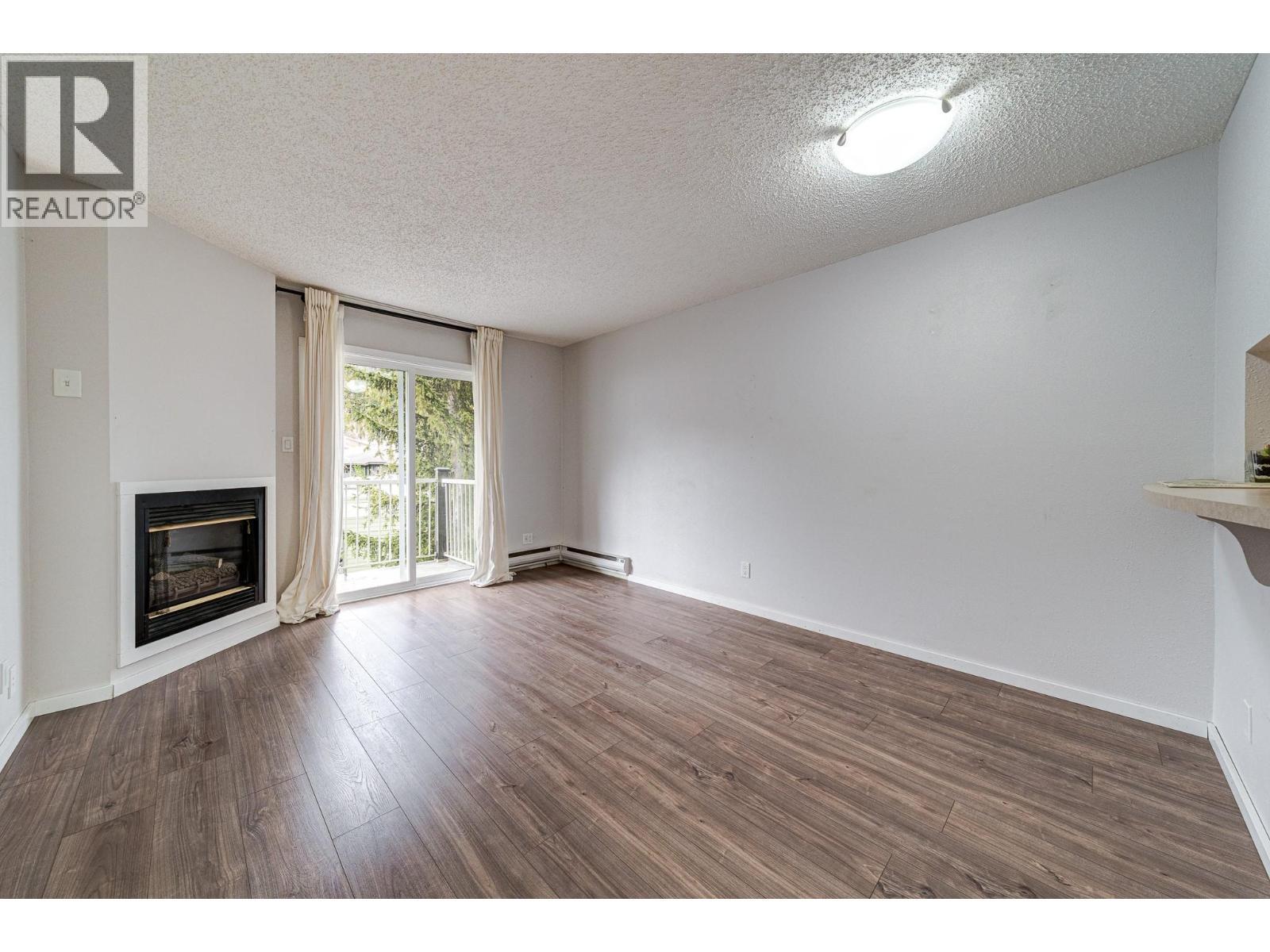 1802 Alpine Drive Unit# 306A, Elkford, BC - Indoor Photo Showing Other Room With Fireplace