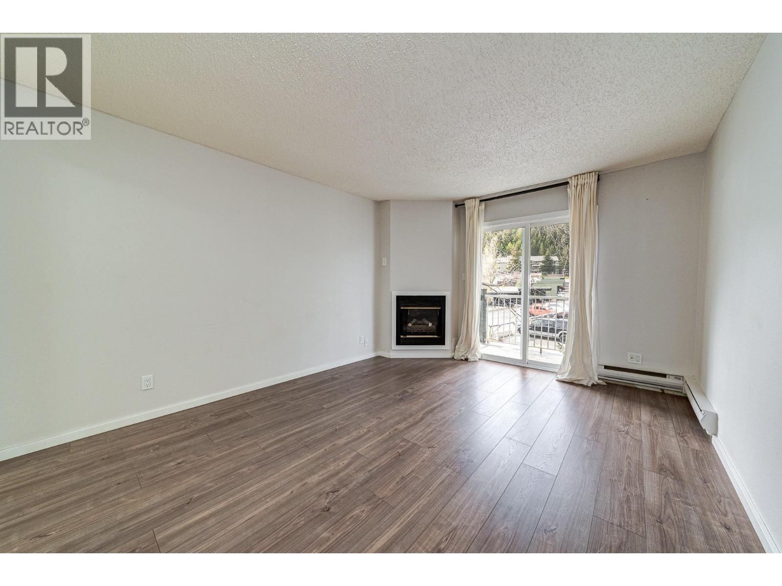 1802 Alpine Drive Unit# 306A, Elkford, BC - Indoor Photo Showing Living Room With Fireplace