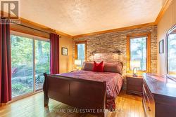 Main level bedroom w/ closet & patio access -