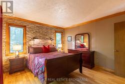 Main level bedroom w/ stone wall feature -