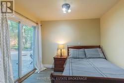 Basement bedroom w/ glass sliding doors to patio -