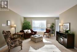 Bright Living Area Overlooking Treed Backyard -