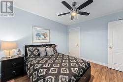 With a closet and ceiling fan -