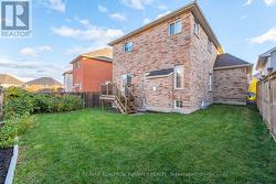 The backyard offers lush landscaping -