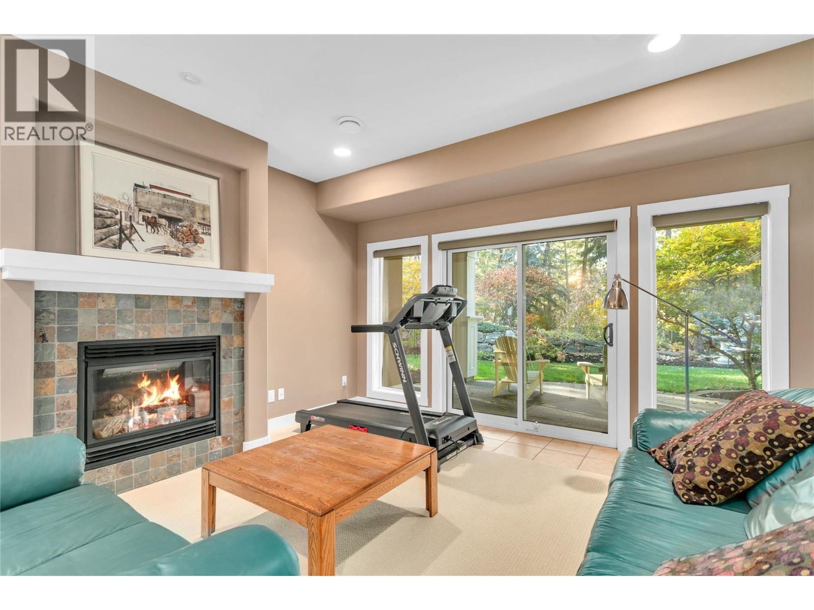 4116 Gallaghers Woodlands Drive S, Kelowna, BC - Indoor Photo Showing Gym Room With Fireplace