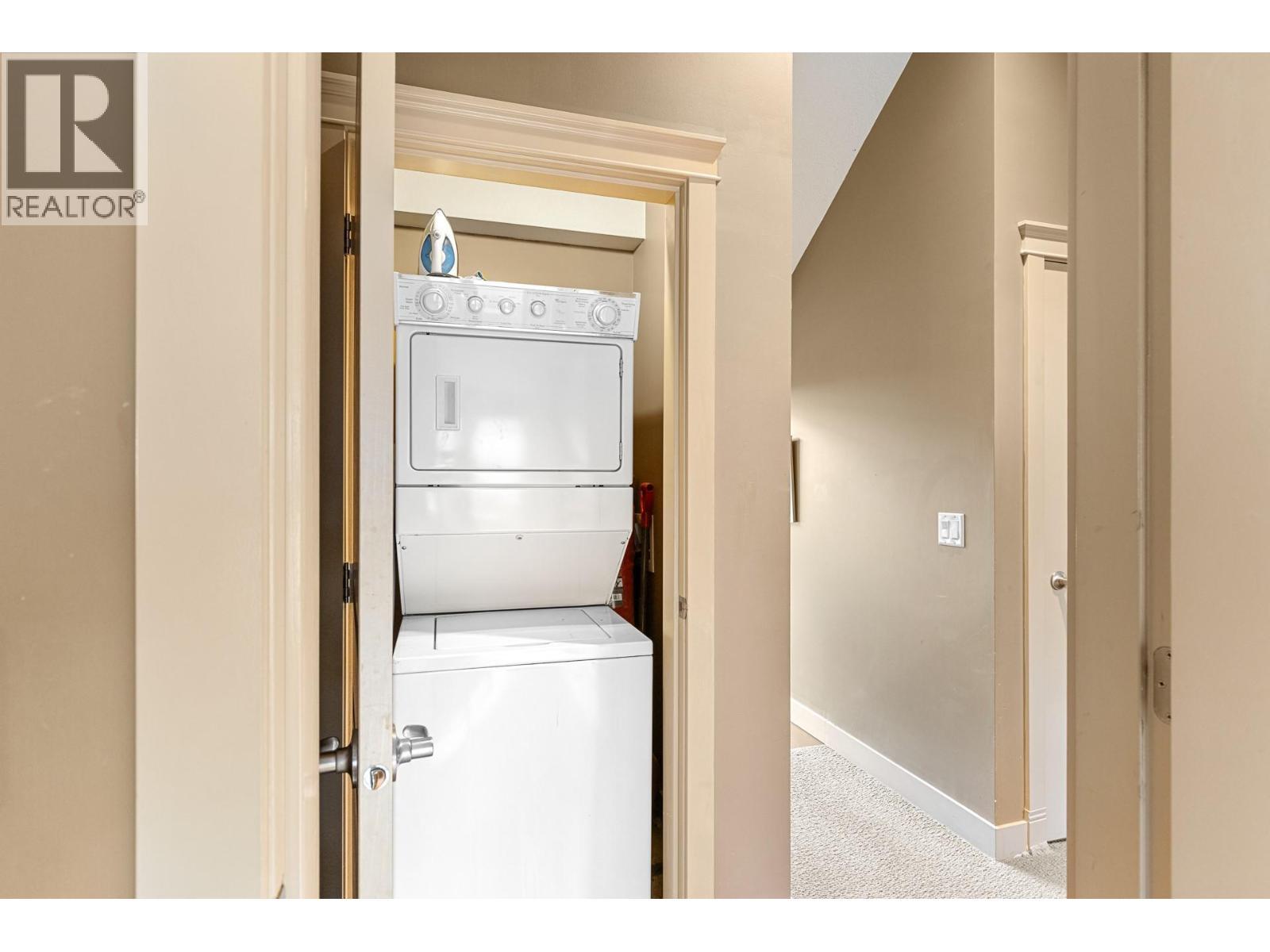 Stacked Laundry in-unit - 1795 Country Club Drive Unit# 201, Kelowna, BC - Indoor Photo Showing Laundry Room