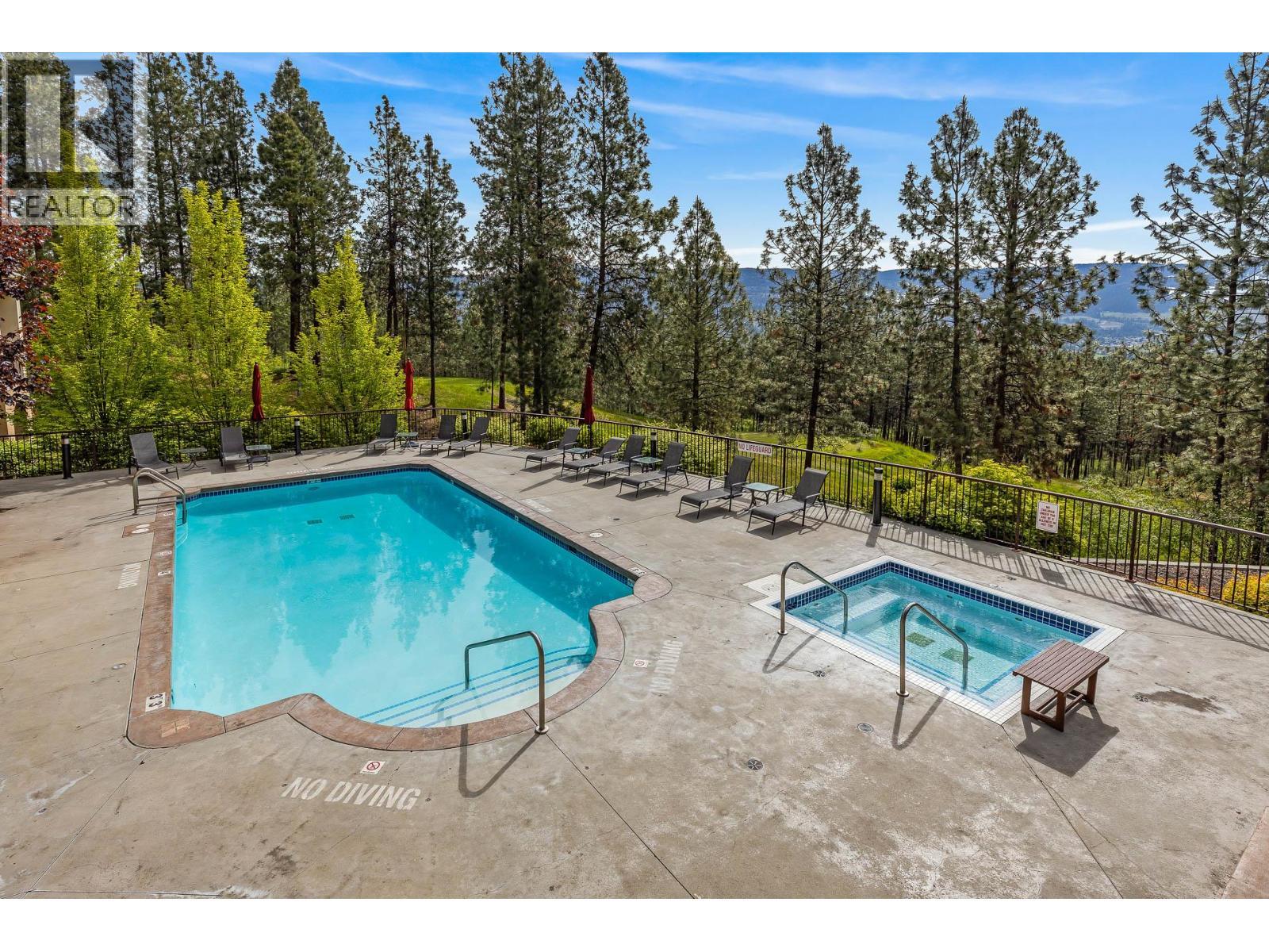 Outdoor pool and hot tub - 1795 Country Club Drive Unit# 201, Kelowna, BC - Outdoor With In Ground Pool With Backyard
