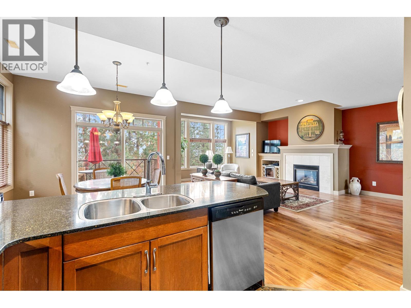 1795 Country Club Drive Unit# 201, Kelowna, BC - Indoor Photo Showing Kitchen With Fireplace With Double Sink