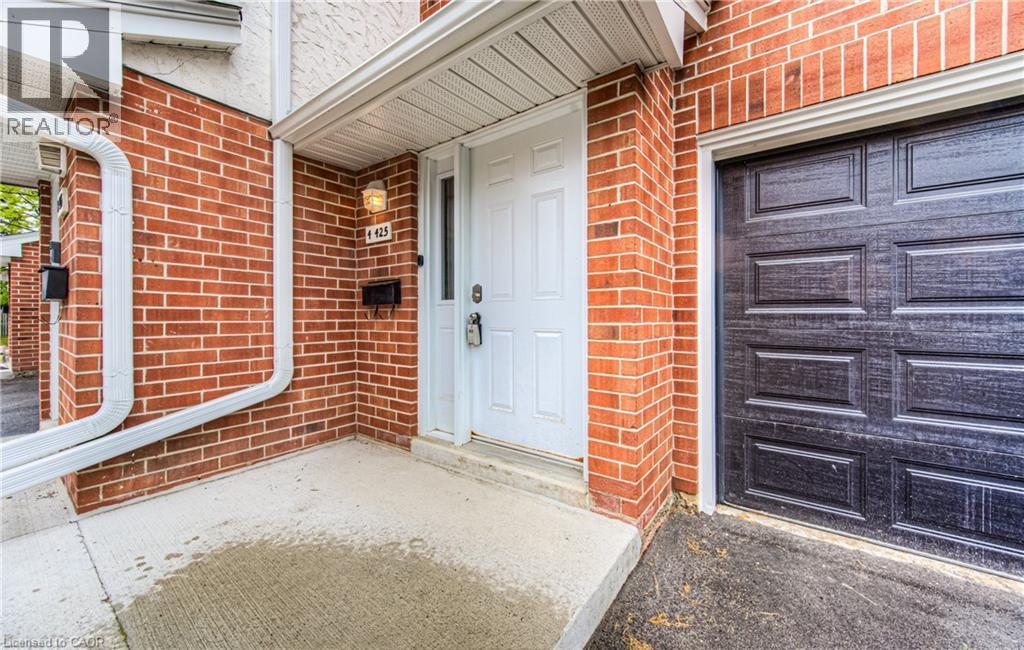 Entrance to property with brick siding and a garage - 425 Keats Way Unit# 4, Waterloo, ON - Outdoor