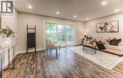 Living area featuring wood finished floors, baseboards, and recessed lighting -