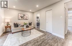 Living area featuring wood finished floors, baseboards, and recessed lighting -