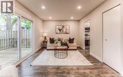 Living room featuring recessed lighting, wood finished floors, and baseboards -