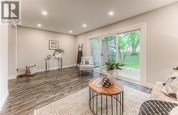 Sitting room featuring baseboards, wood finished floors, and recessed lighting -