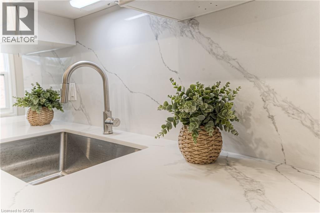 Kitchen view of a sink and light stone counters - 425 Keats Way Unit# 4, Waterloo, ON - Indoor