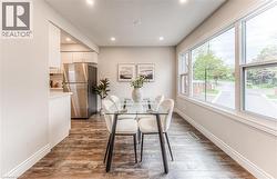 Dining space featuring recessed lighting, dark wood-style floors, and baseboards -