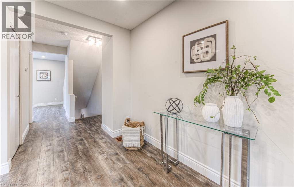 Hallway with wood finished floors, baseboards, and an upstairs landing - 425 Keats Way Unit# 4, Waterloo, ON - Indoor Photo Showing Other Room