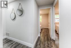 Corridor with dark wood finished floors and baseboards -