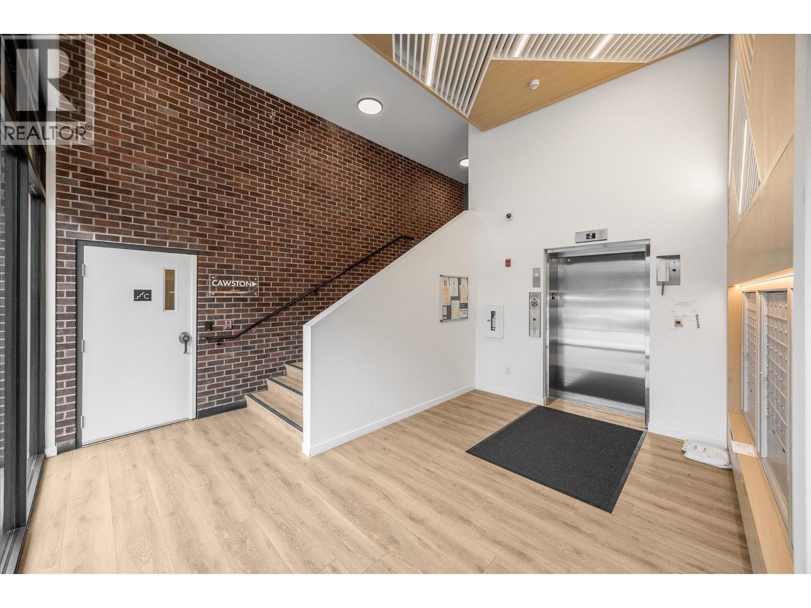 Fob needed to use the elevator, and elevator monitored 24/7 - 660 Cawston Avenue Unit# 313, Kelowna, BC - Indoor Photo Showing Other Room