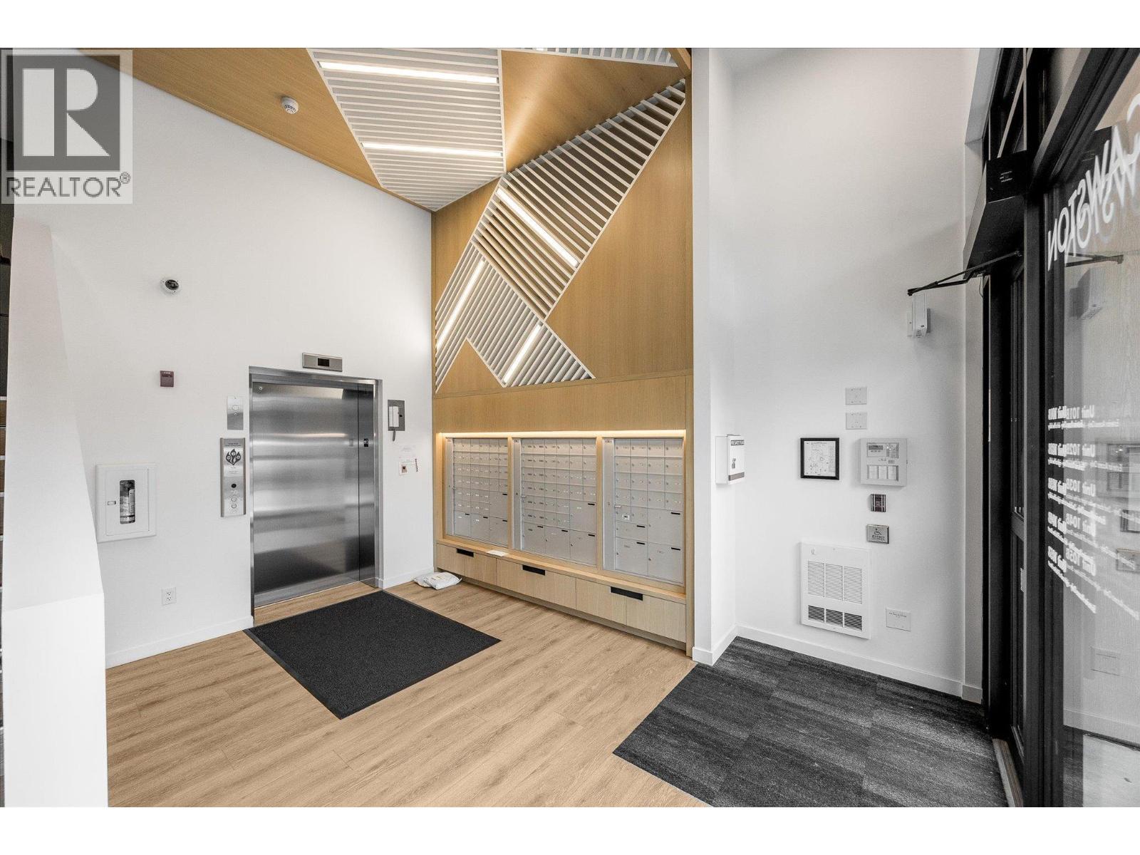 Mail boxes located in the building foyer - 660 Cawston Avenue Unit# 313, Kelowna, BC - Indoor Photo Showing Other Room