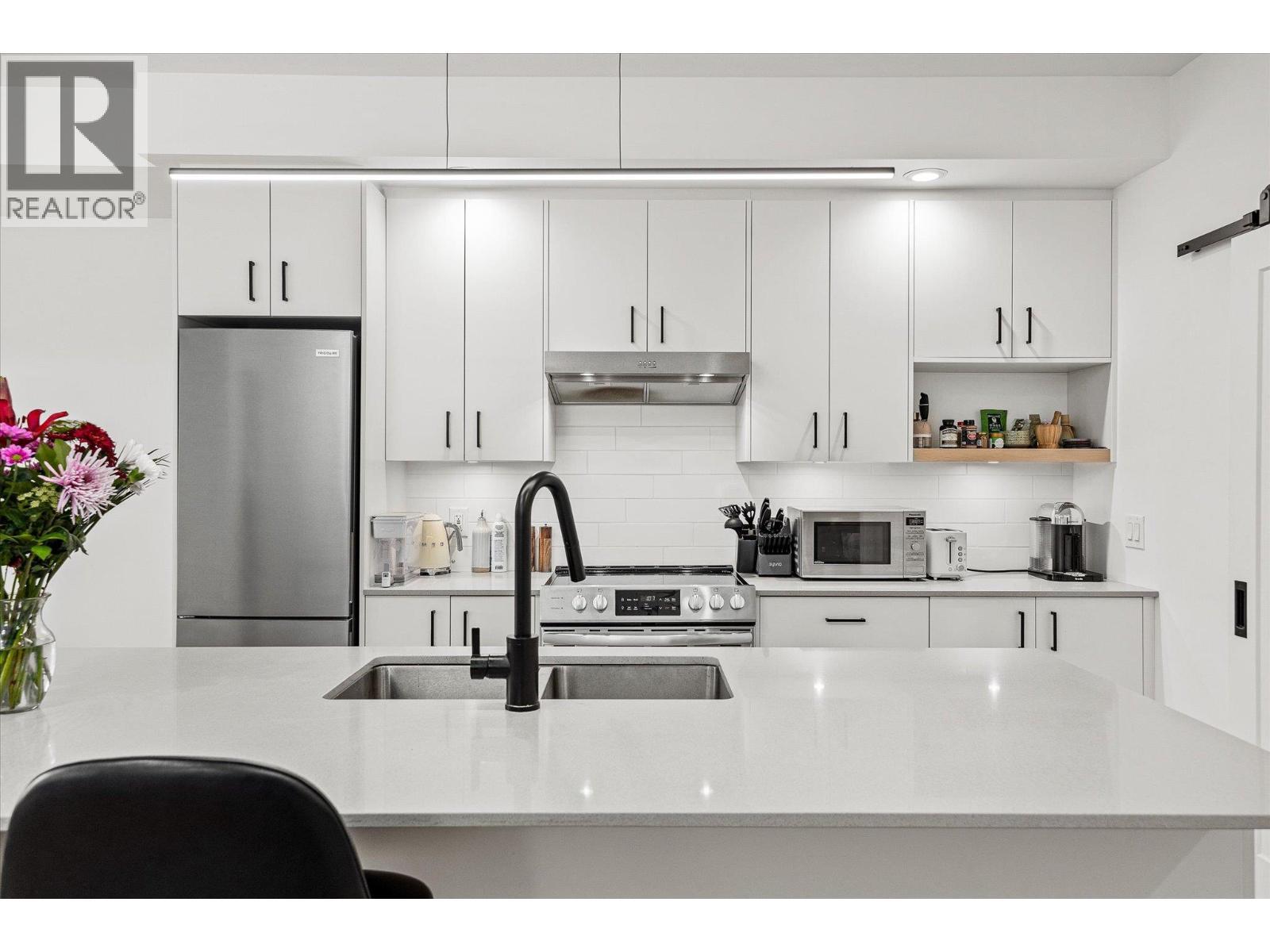 All appliances are stainless steel Frigidaire (2022) - 660 Cawston Avenue Unit# 313, Kelowna, BC - Indoor Photo Showing Kitchen With Upgraded Kitchen