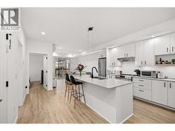 Light Oak Hardwood style flooring throughout the condo. -