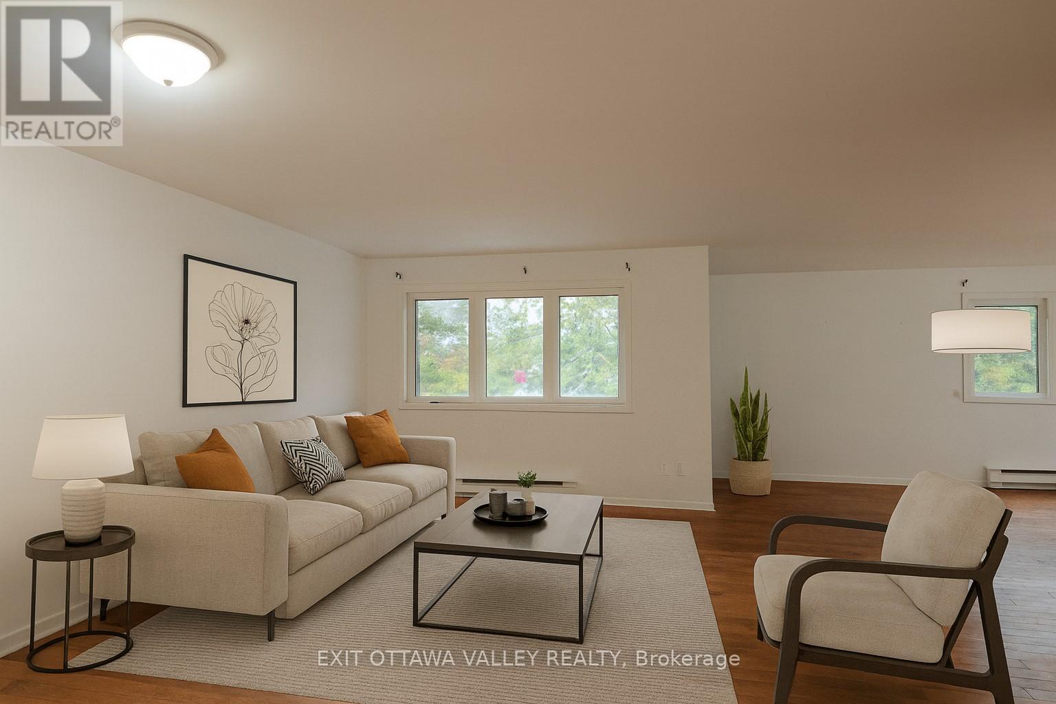 Virtually staged living area - 3 - 10 Charles Street, Arnprior, ON - Indoor Photo Showing Living Room