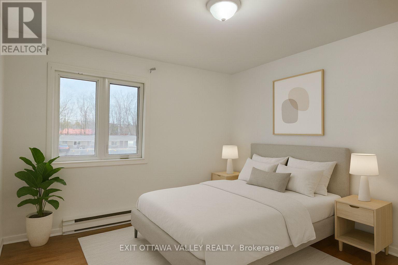 Virtually staged primary bedroom - 3 - 10 Charles Street, Arnprior, ON - Indoor Photo Showing Bedroom