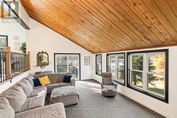 Cozy sunken living room w wall of windows -