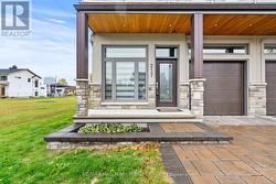 VERANDAH, GARAGE, and interlock driveway. -