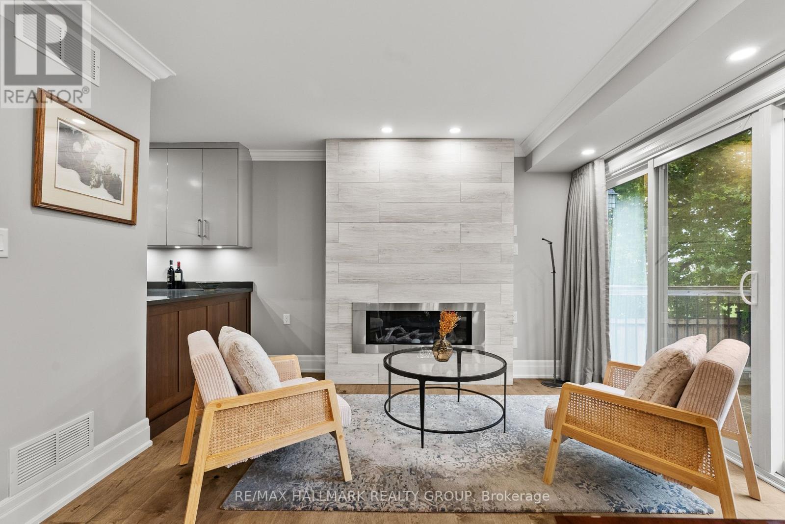 LIVING ROOM has gas fireplace with shiplap trim. - 217 Belford Crescent, Ottawa, ON - Indoor Photo Showing Other Room With Fireplace