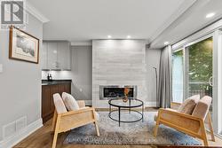 LIVING ROOM has gas fireplace with shiplap trim. -