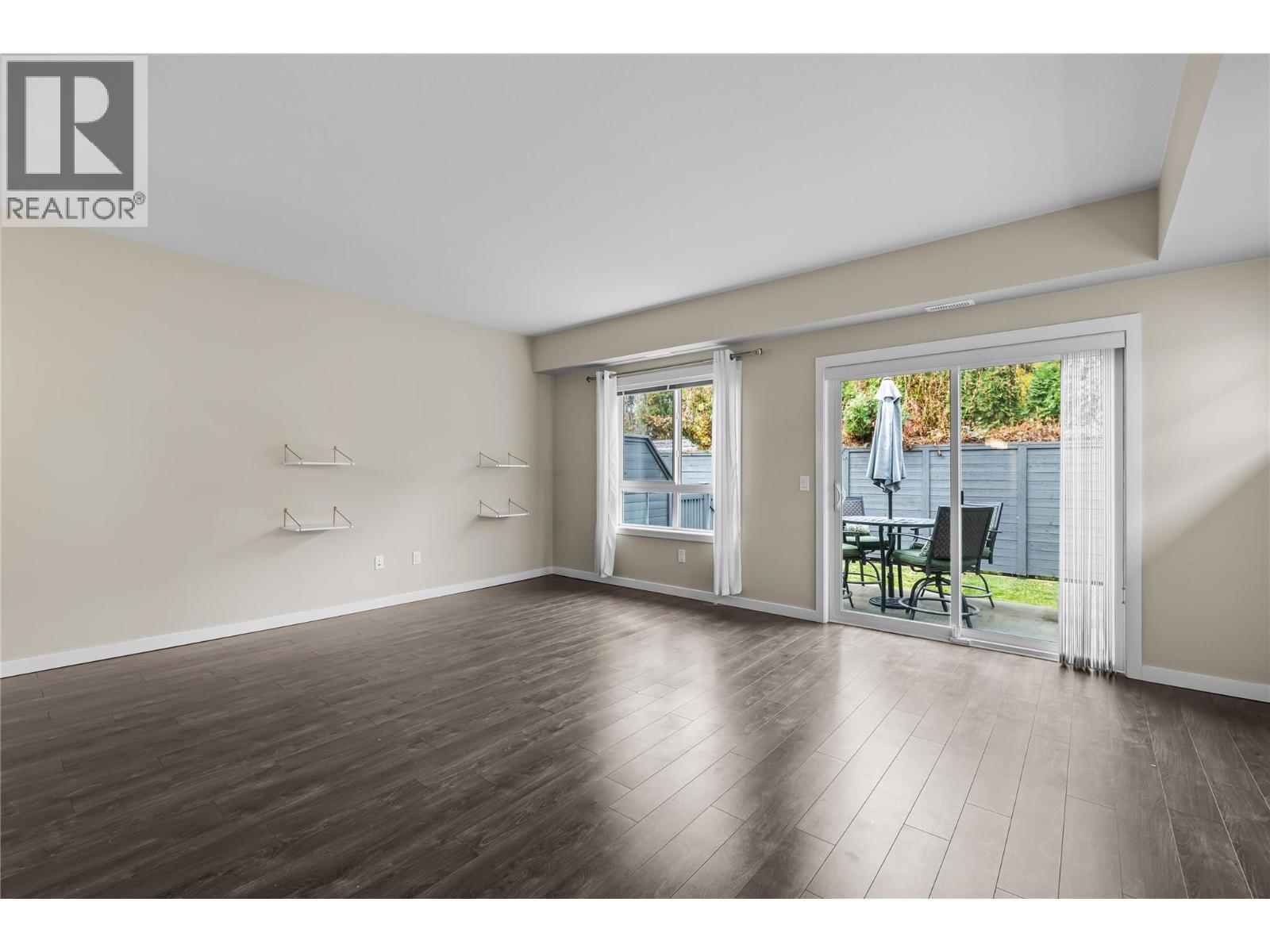 Living Room with Patio access - 680 Old Meadows Road Unit# 86, Kelowna, BC - Indoor