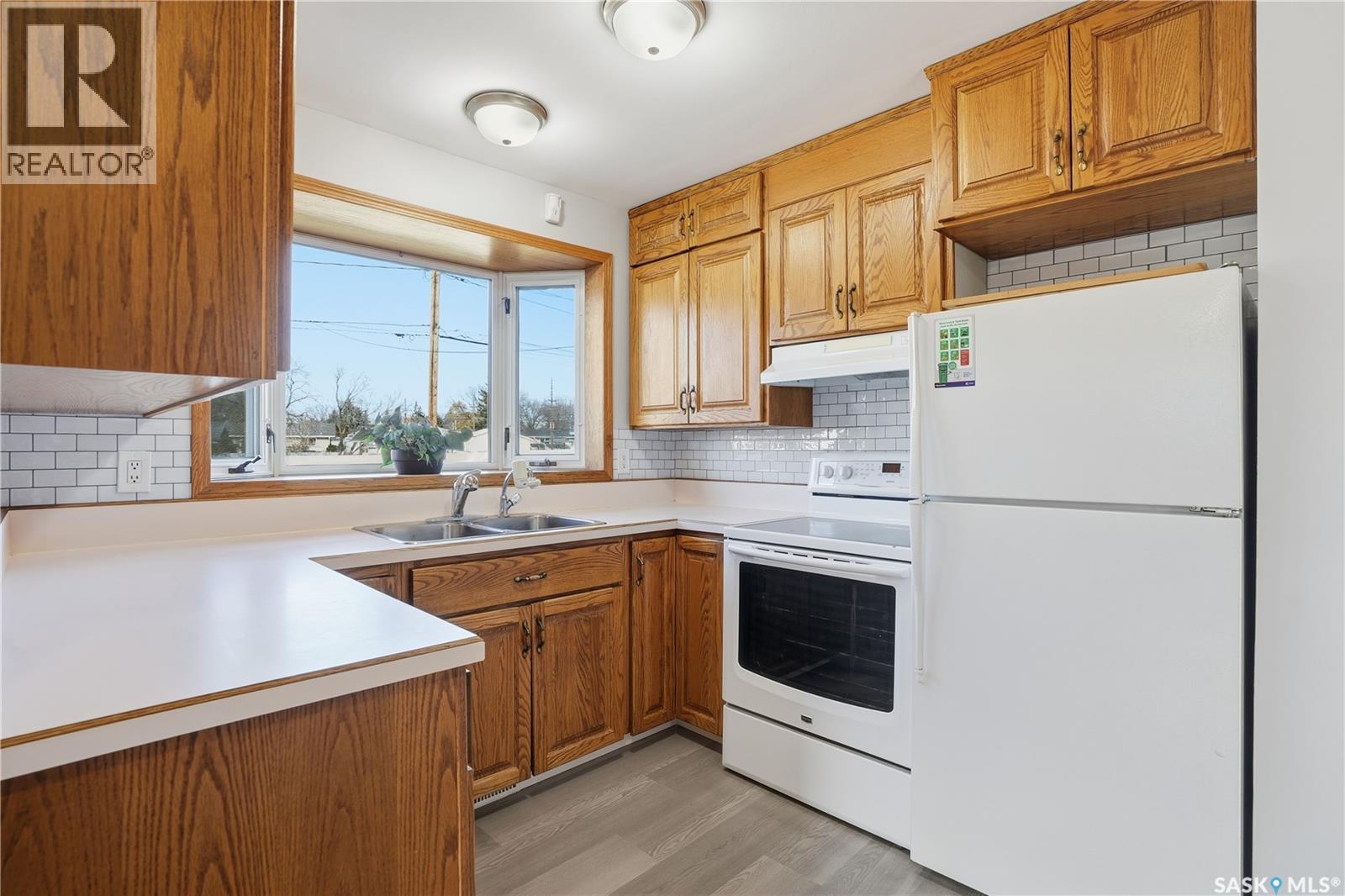 128 Yarnton Crescent, Regina, SK - Indoor Photo Showing Kitchen With Double Sink