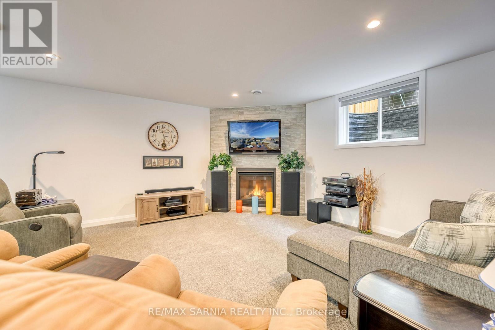 393 Bayhill Drive, St. Clair, ON - Indoor Photo Showing Living Room With Fireplace