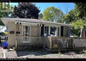 Back of house featuring a deck and brick siding - 121 Roberts Crescent Unit# Upper, Kitchener, ON - Outdoor