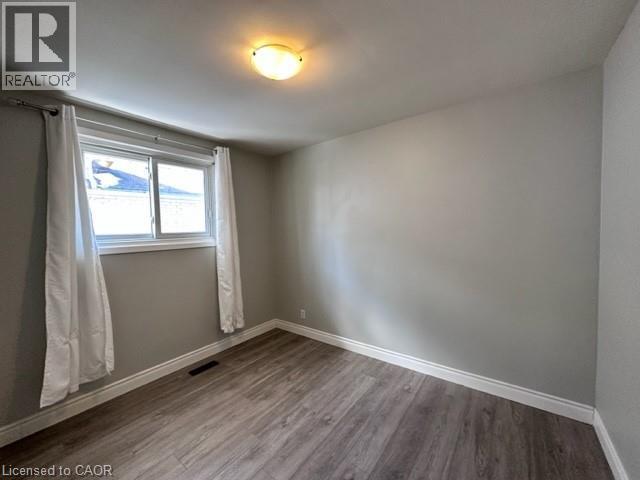 Spare room featuring baseboards and wood finished floors - 121 Roberts Crescent Unit# Upper, Kitchener, ON - Indoor Photo Showing Other Room
