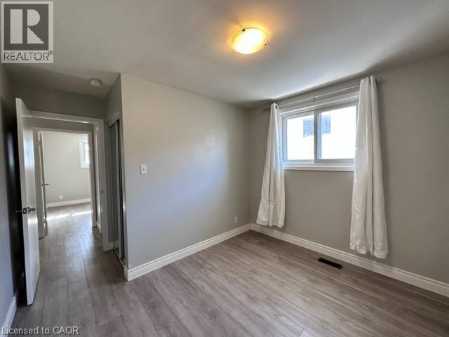 Unfurnished room with light wood-style flooring - 121 Roberts Crescent Unit# Upper, Kitchener, ON - Indoor Photo Showing Other Room