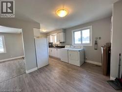 Laundry room with light wood-type flooring and independent washer and dryer -