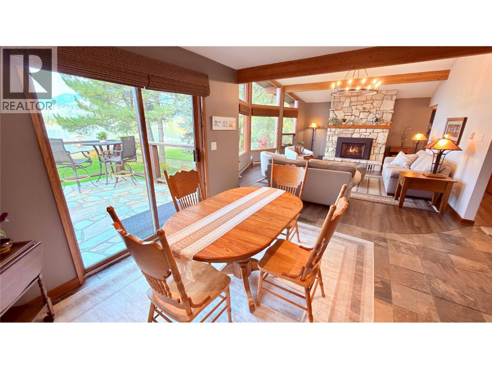 102 Sandner Road, Christina Lake, BC - Indoor Photo Showing Dining Room With Fireplace