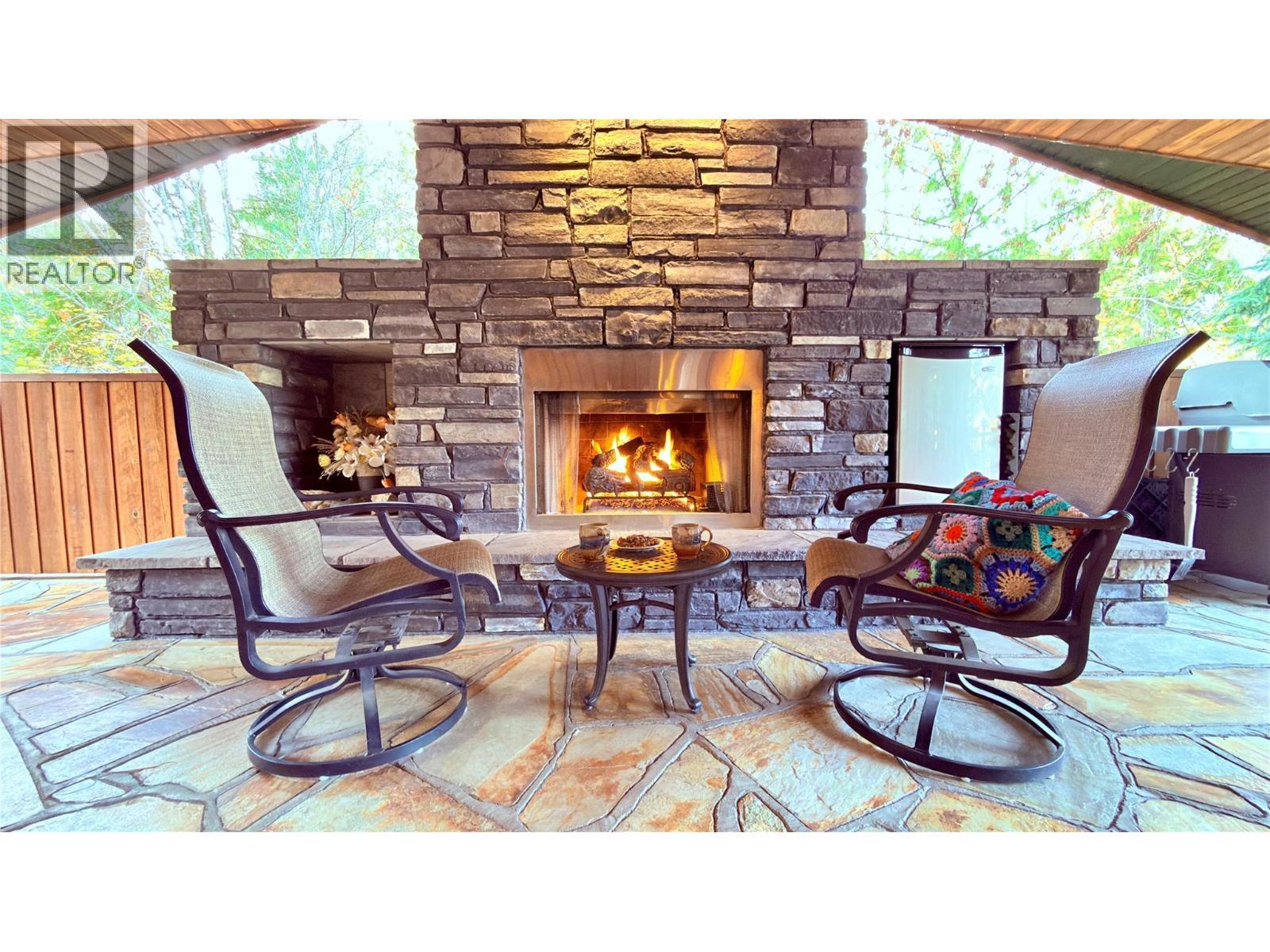 102 Sandner Road, Christina Lake, BC - Outdoor With Fireplace With Deck Patio Veranda