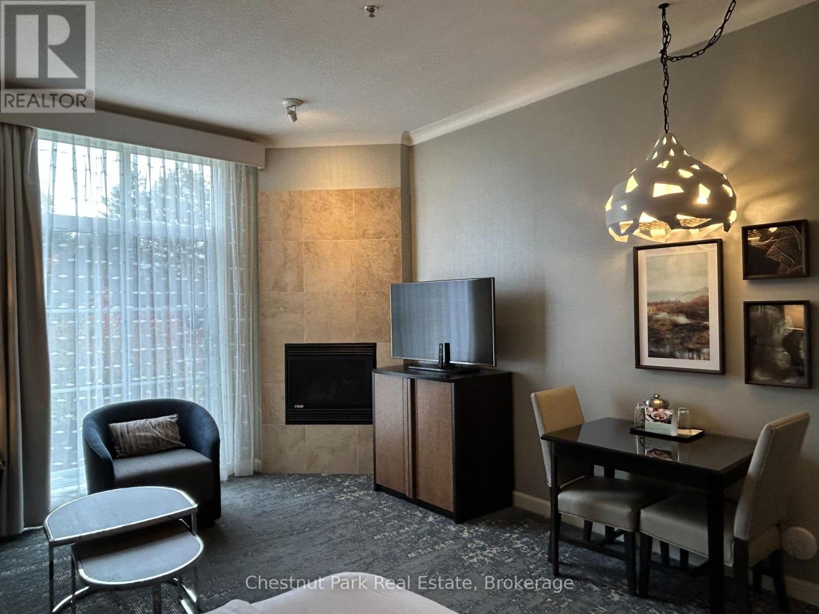 165 - 220 Gord Canning Drive, Blue Mountains, ON - Indoor Photo Showing Dining Room With Fireplace