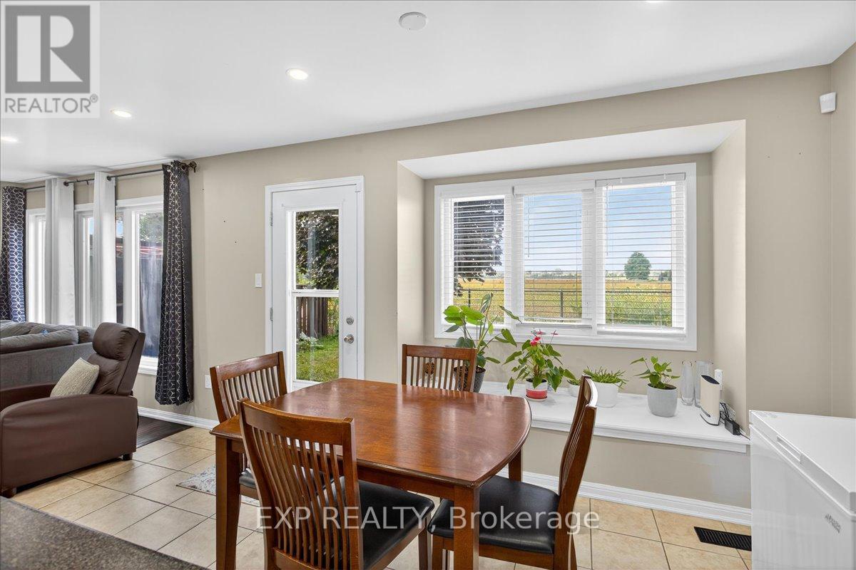 Bright Bay Window overlooking open fields - 38 John W Taylor Avenue, New Tecumseth, ON - Indoor Photo Showing Dining Room
